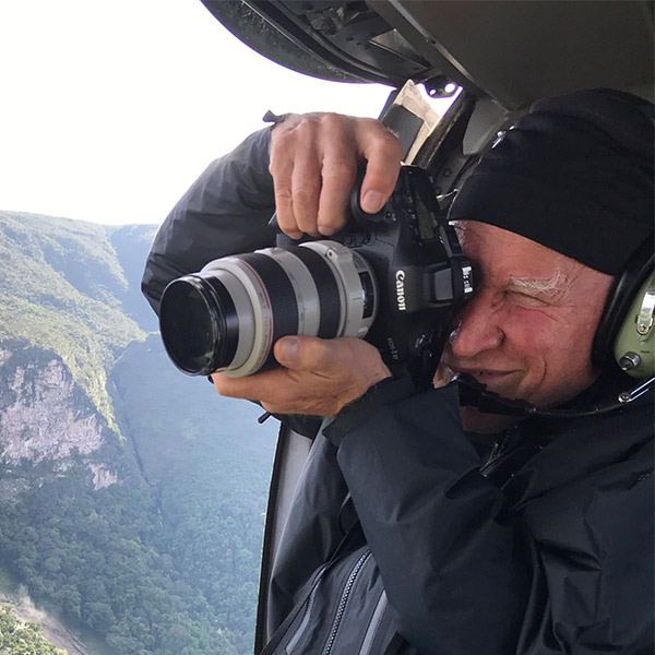 Sebastião Salgado taking photos out of a helicopter