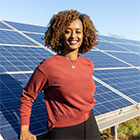 woman in front of solar panel