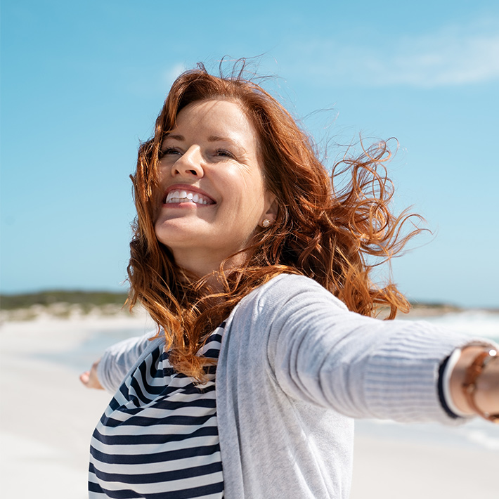 a happy woman on the beach