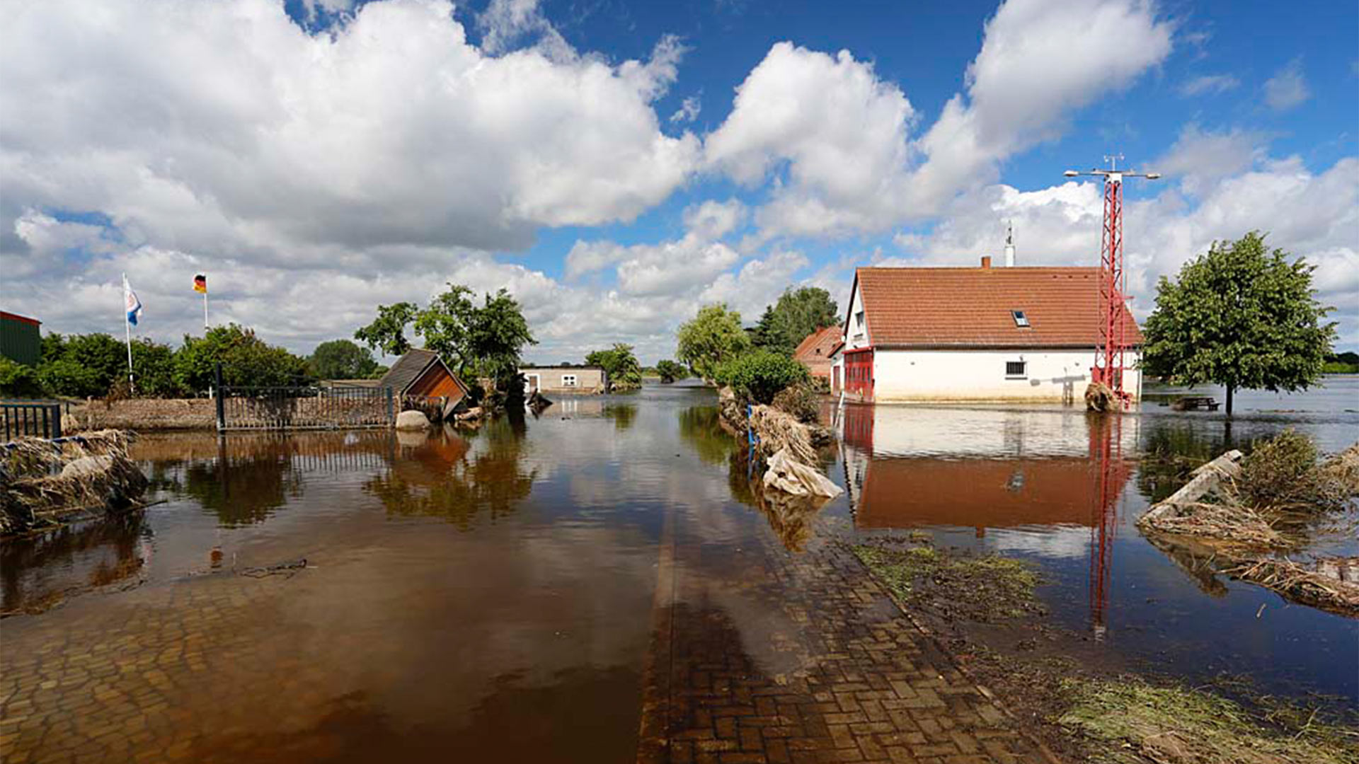 a flooded street and house